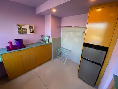 a kitchen with pink walls and a refrigerator at The Bernardi House in Los Angeles
