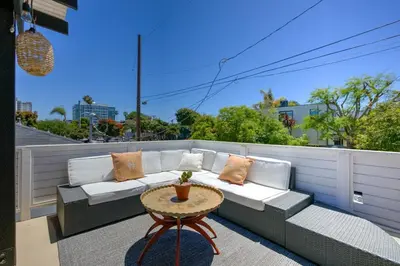 a couch sitting on a balcony with a table at Private Venice Beach Loft - Steps to the Beach & Canals in Los Angeles
