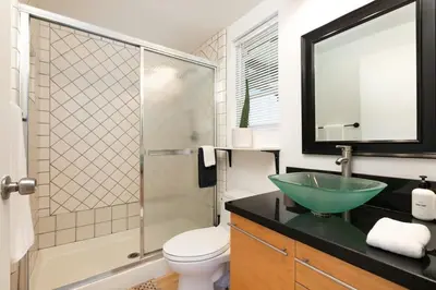 a bathroom with a glass bowl sink and a shower at Private Venice Beach Loft - Steps to the Beach & Canals in Los Angeles