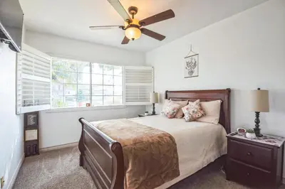 a bedroom with a bed and a ceiling fan at Peaceful Oasis in Anaheim