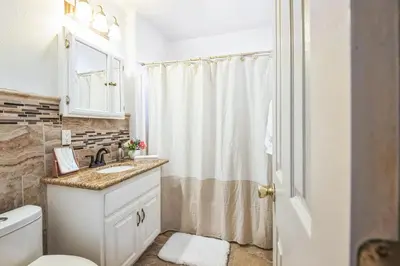 a bathroom with a sink and a toilet and a shower at Peaceful Oasis in Anaheim