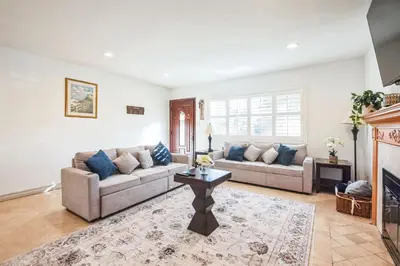 a living room with two couches and a fireplace at Peaceful Oasis in Anaheim