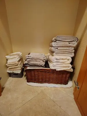 a pile of folded towels in a laundry room at Peaceful Oasis in Anaheim
