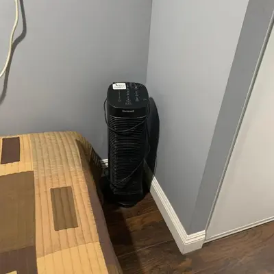 a black wii controller sitting in the corner of a room at Cozy Room in Bakersfield