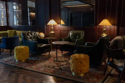 a waiting room with chairs and tables and lamps at Whisky Hotel in Los Angeles