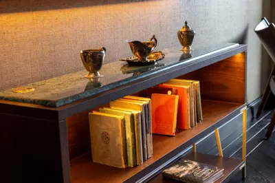 a table with books and vases on it at Whisky Hotel in Los Angeles