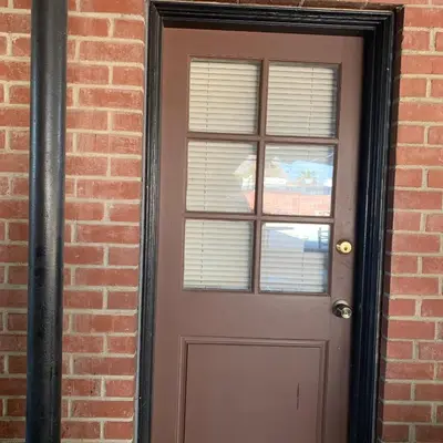 a door in a brick building with a window at Cozy Room in Bakersfield