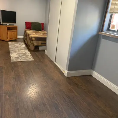 a room with a bed and a television in it at Cozy Room in Bakersfield