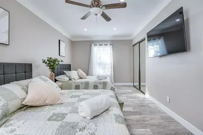 a bedroom with two beds and a flat screen tv at 7 Mi to Downtown East Los Angeles Apartment in East Los Angeles