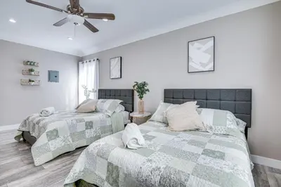 a bedroom with two beds and a ceiling fan at 7 Mi to Downtown East Los Angeles Apartment in East Los Angeles
