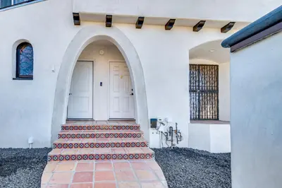 a white building with a white door and stairs at 7 Mi to Downtown East Los Angeles Apartment in East Los Angeles