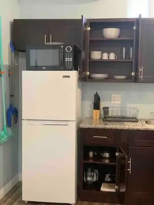 a kitchen with a white refrigerator and a microwave at Private Sanctuary in Montebello in Montebello