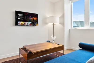 a living room with a couch and a table at Bright Studio on Sunset Blvd Pool, Parking, Gym in Los Angeles