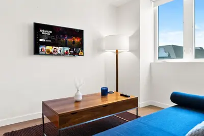 a living room with a couch and a table at Bright Studio on Sunset Blvd Pool, Parking, Gym in Los Angeles