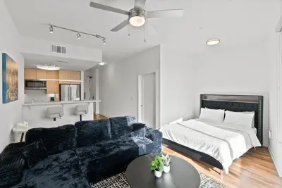 a bedroom with a bed and a couch at Mid-Wilshire Studio Free Parking, Pool, Gym in Los Angeles