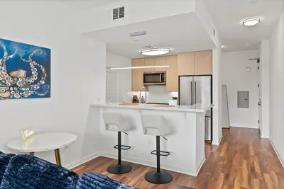 a kitchen and living room with a counter and a table at Mid-Wilshire Studio Free Parking, Pool, Gym in Los Angeles