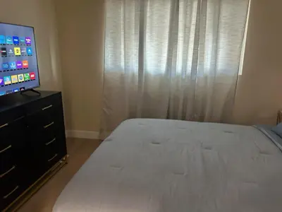 a bedroom with a bed and a flat screen tv at Private Hillside Home with View - Yaamava - NOS in San Bernardino