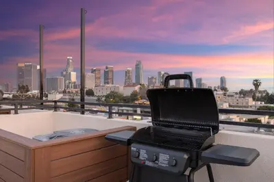 a grill on a balcony with a view of a city at LA Rooftop Paradise 2 in Los Angeles
