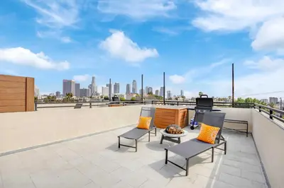 a patio with chairs and a television on a roof at LA Rooftop Paradise 2 in Los Angeles