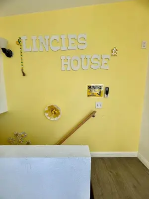a yellow wall with the words miracles house on it at Lemon Studio with Mountain view in Rosemead