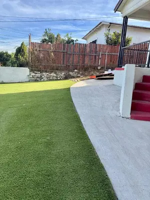 a house with a yard with a fence and a lawn at Lemon Studio with Mountain view in Rosemead