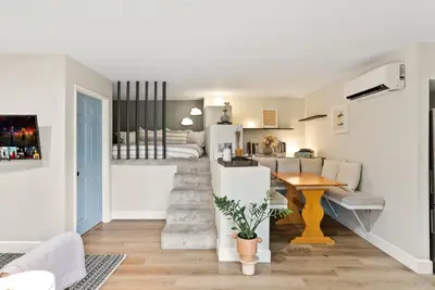 a living room with a staircase leading to a bedroom at Designer Laurel Canyon Retreat, Hollywood Hills in Los Angeles