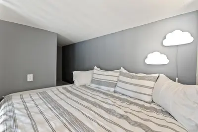 a bedroom with a bed with clouds on the wall at Designer Laurel Canyon Retreat, Hollywood Hills in Los Angeles