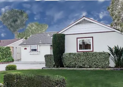 a white house with bushes in the front yard at MagicwayVillas Mickey's Pool Club House - Pool & Spa - Walking to Disneyland in Anaheim