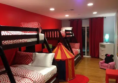 a room with two bunk beds and a red wall at MagicwayVillas Mickey's Pool Club House - Pool & Spa - Walking to Disneyland in Anaheim