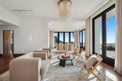 a living room with couches and a chandelier at Serene by Stay Awhile Villas in Los Angeles