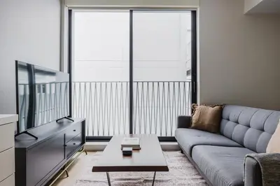a living room with a couch and a tv at Blueground Downtown elevator nr parks LAX-1240 in Los Angeles