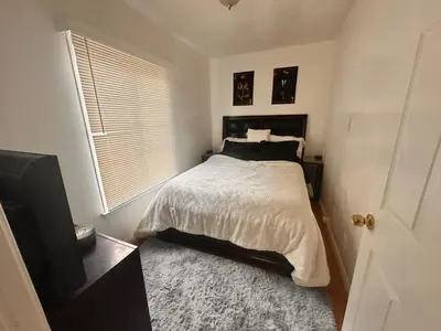 a bedroom with a bed and a flat screen tv at Del in Los Angeles