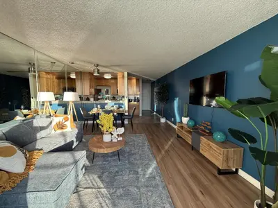 a living room with a blue wall at Oceanfront 1 BR Oasis w Parking & Pool 107 in Redondo Beach