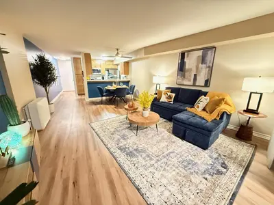 a living room with a blue couch and a table at Oceanfront 1 BR Oasis w Parking & Pool 417 in Redondo Beach