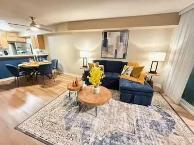 a living room with a blue couch and a table at Oceanfront 1 BR Oasis w Parking & Pool 417 in Redondo Beach