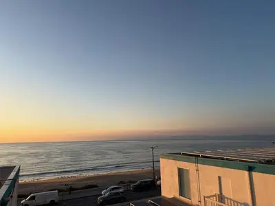 a view of the ocean at sunset from a building at Oceanfront 1 BR Oasis w Parking & Pool 417 in Redondo Beach
