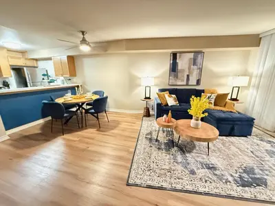 a living room with a blue couch and a table at Oceanfront 1 BR Oasis w Parking & Pool 417 in Redondo Beach