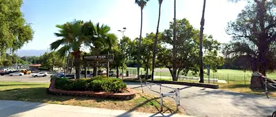 a park with a sign and palm trees and a parking lot at Style, Peace, Comfort in N Hollywood Next to Burbank Free Indoor Parking and Wifi in Burbank