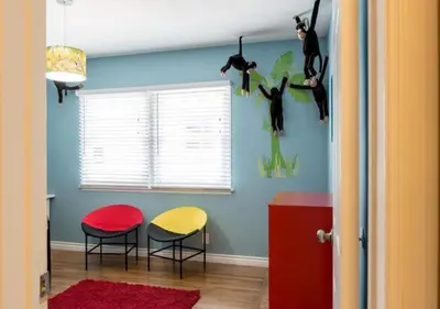 a room with two chairs and a table and a wall at Tiki House and Spa - Walking Distance to Dsineyland in Anaheim