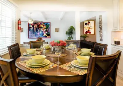 a dining room with a wooden table and chairs at Tiki House and Spa - Walking Distance to Dsineyland in Anaheim