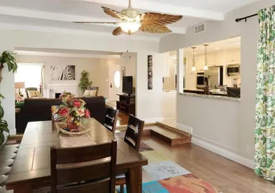 a dining room and living room with a dining table at Tiki House and Spa - Walking Distance to Dsineyland in Anaheim
