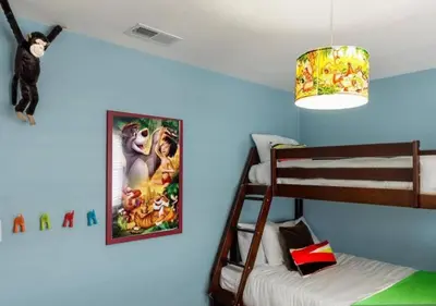 a bedroom with a lion king poster on the wall at Tiki House and Spa - Walking Distance to Dsineyland in Anaheim