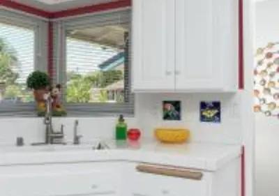 a kitchen with white cabinets and a sink and a window at MagicwayVillas TeaCup Pool House - Walking Distance to Disneyland in Anaheim