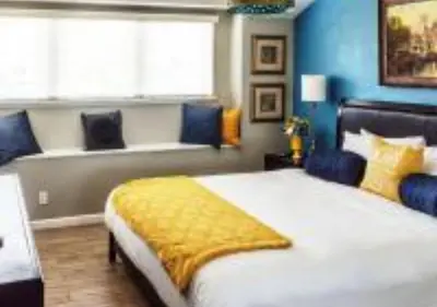 a bedroom with a large white bed and blue walls at MagicwayVillas TeaCup Pool House - Walking Distance to Disneyland in Anaheim
