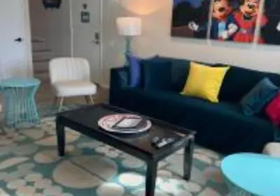 a living room with a blue couch and a coffee table at Magicway Villas Mini's Poolside and Spa - Across Disneyland in Anaheim