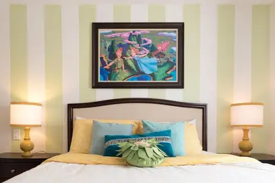 a bedroom with a bed with two lamps and a painting at Magicwayvillas Micky's Playground Pool & Spa - Walking TO Disney in Anaheim