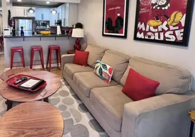 a living room with a couch and a table at MagicwayVillas Mick's ClockHouse Pool & Spa - Walk to Disneyland in Anaheim