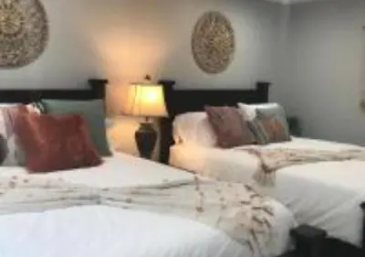 a bedroom with two beds and a lamp in it at Magicwayvillas Micky's HideAway in Fullerton