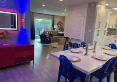 a dining room with a table and chairs and a living room at MagicwayVillas HeroHouse Pool and Spa in Fullerton