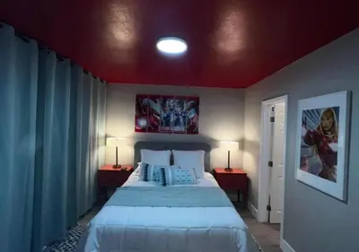 a bedroom with a large bed and two lamps on tables at MagicwayVillas HeroHouse Pool and Spa in Fullerton